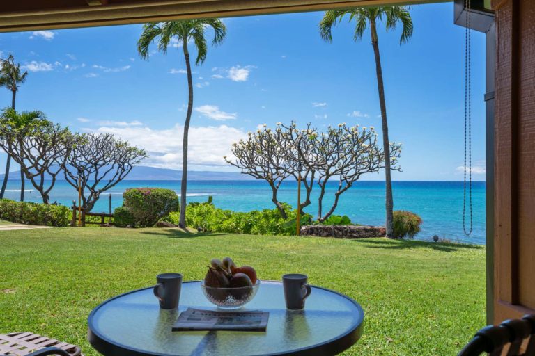 Photo of ground level private patio with ocean and Lanai Island view. Room 107